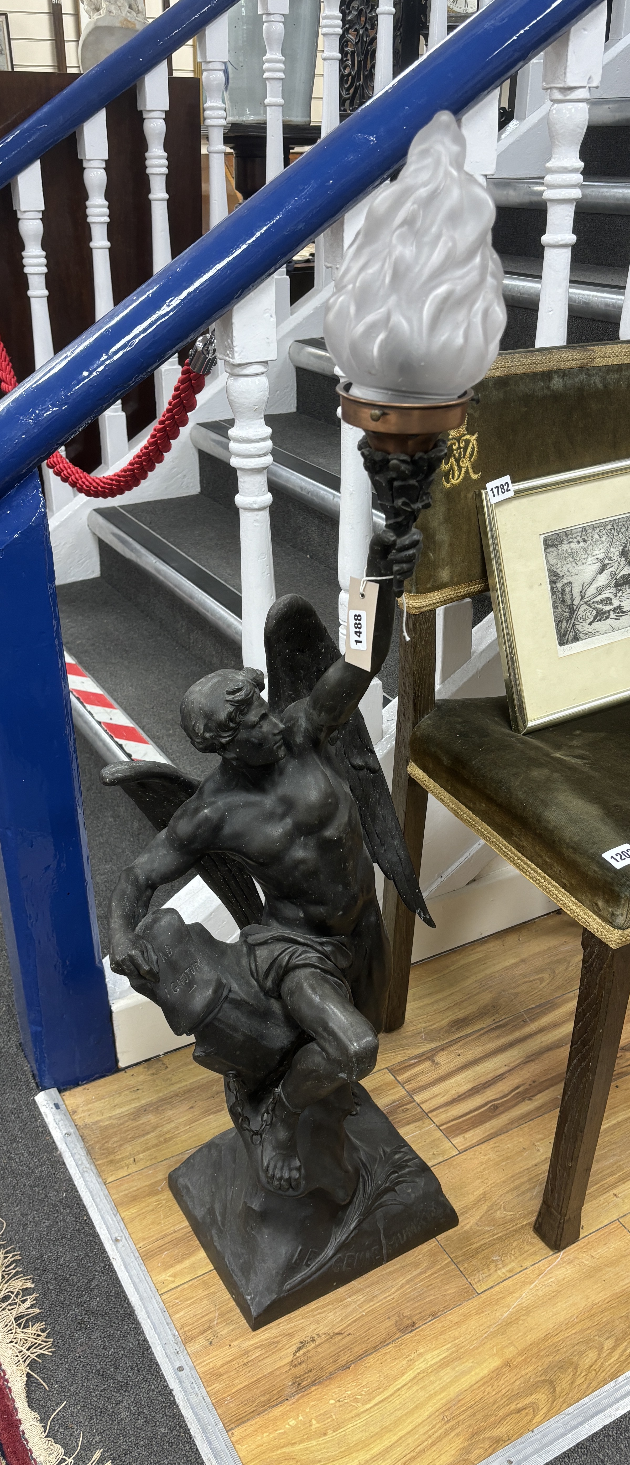 A large spelter angel torchere, with flame glass shade 109cm high
